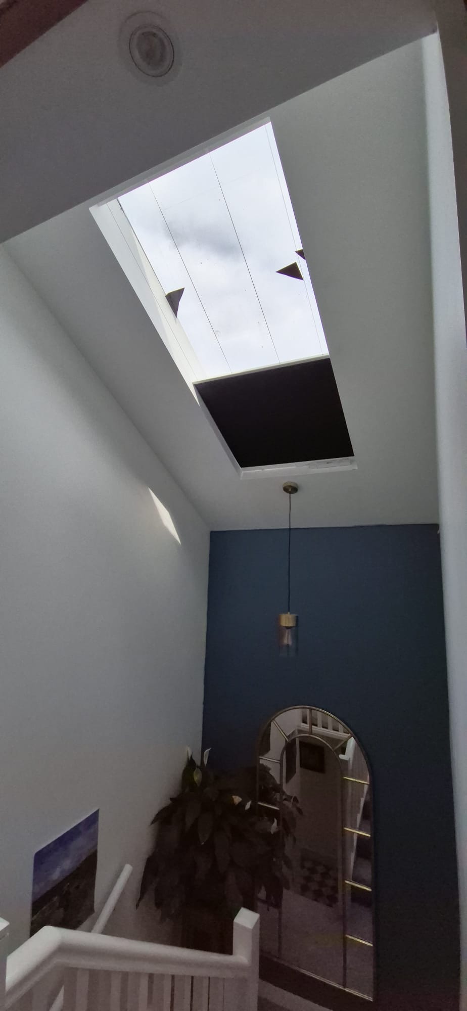 Anthracite blackout honeycomb blind fitted on the slope roof above stair case