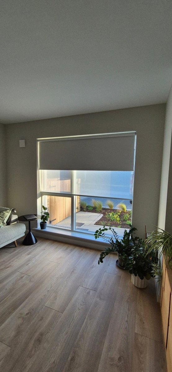 Somfy motorised cream blackout roller blinds - Manor Interiors