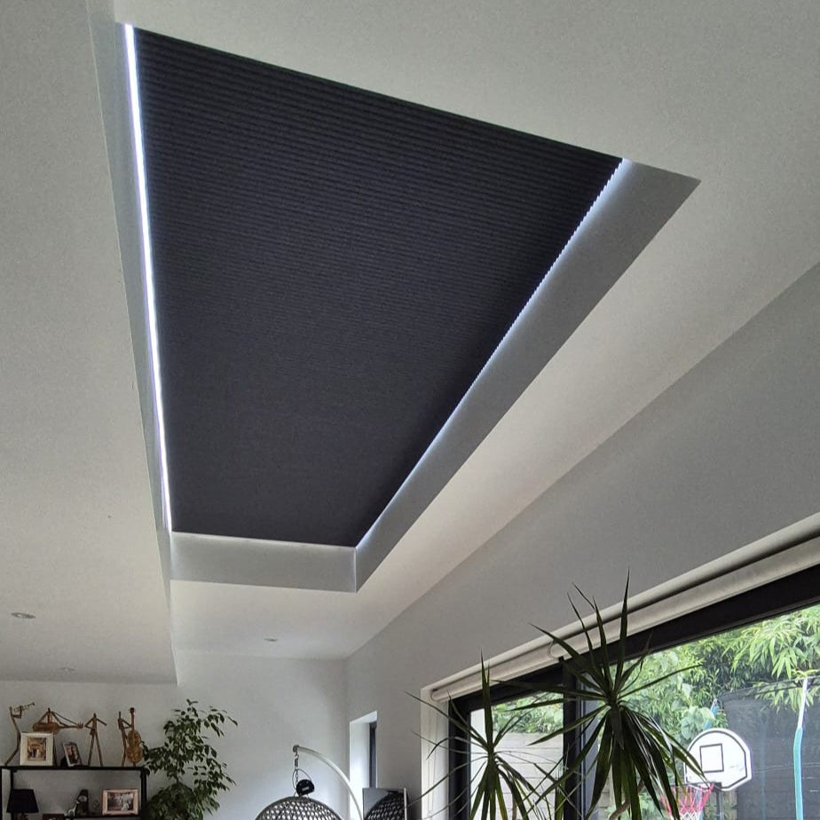 Honeycomb motorised pleated blinds fitted on flat roof skylight window on extention